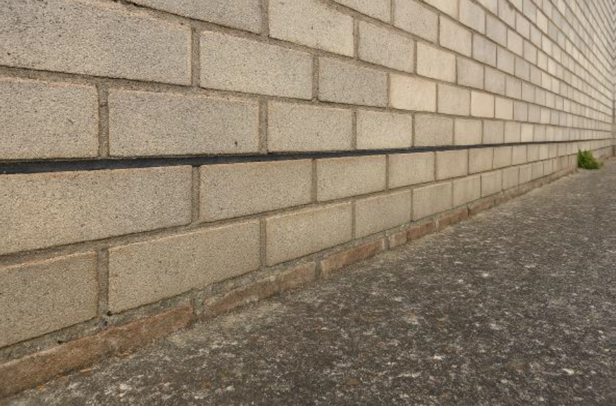 Visible damp proof course in wall